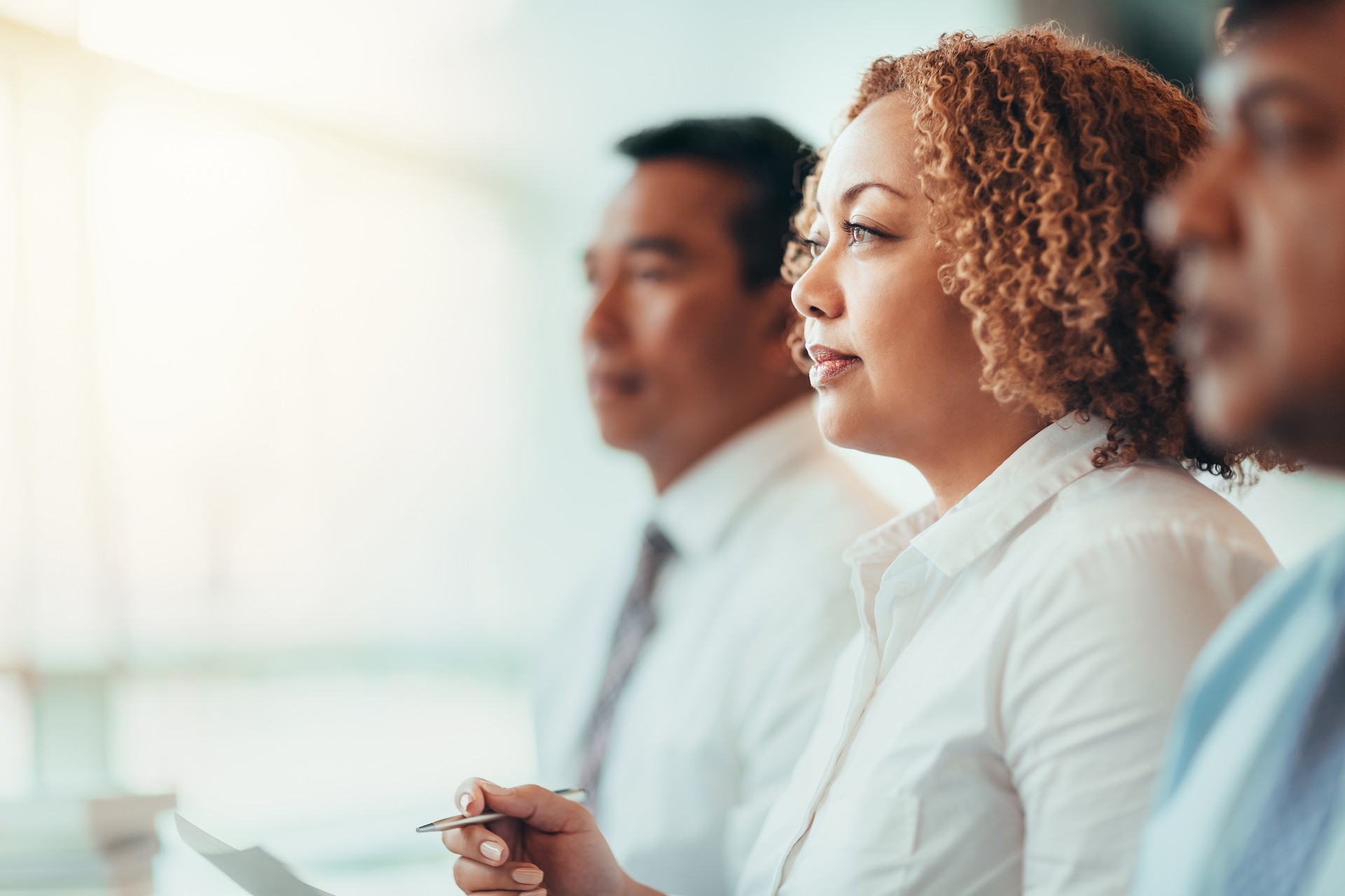 Japanese African-American mature businesswoman student sitting learning listening in education training seminar meeting in business office classroom with multiracial colleagues